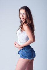Fashion shot: cute young girl in denim shorts and shirt