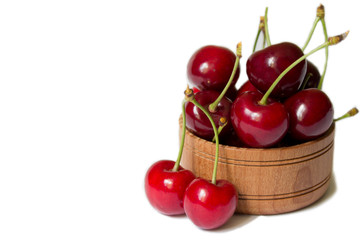 Cherry in wooden bowl isolated on white background