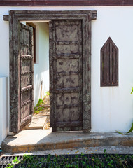 the white wall and the gate, the door carved with a national ornament. Thailand