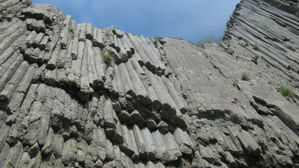Up-view to Rocks of Stolbchatiy cape in Kunashir, kuril islands, Russia