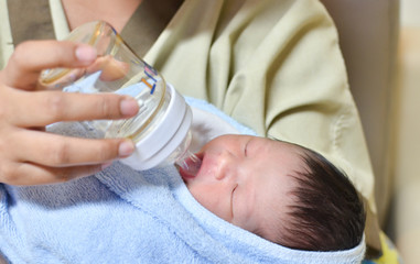 mother is feeding her newborn baby in the hospital