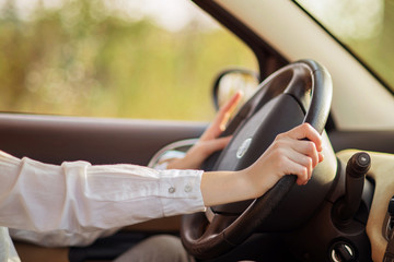 girl inside car behind the steering wheel