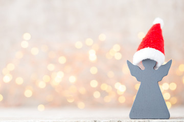 Christmas decor with angel santa hat. Vintages background.