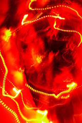 Chaotic lights in moriol blur out of focus - abstract photograph background.