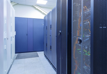 room with rows of server hardware in data center