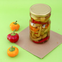 orange and red hot chili pepper and canned peppers in jar