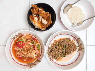 Top view of Papaya salad with Spicy minced pork,Fried chicken and Sticky rice,Thai local food