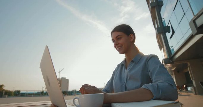 Beautiful girl in business clothes corresponds with the client