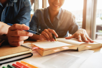 Student Studying Brainstorming Campus Concept.close up of students hands with books or textbooks writing to notebooks