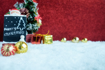 Christmas decorations with snow and red background.close up and selective focus.