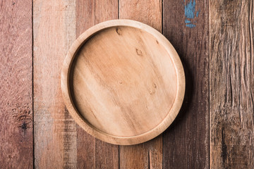 Top view of  wooden dish on wooden table background.