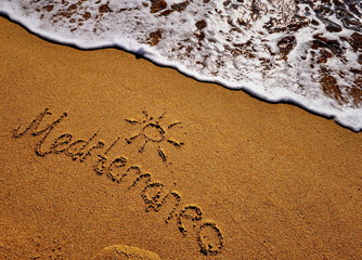 Fototapeta premium Mediterranean sign on the sand beach
