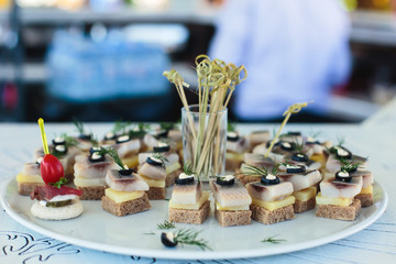 Beautifully decorated catering banquet table with different food snacks and appetizers on event