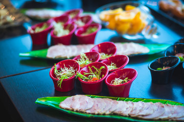 Beautifully decorated catering banquet table with different food snacks and appetizers on event