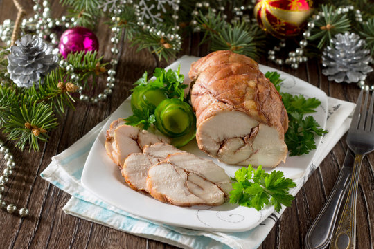 Roll of chicken, baked meat with red wine on the festive Christm