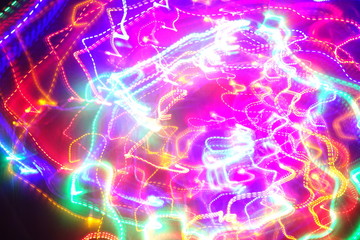 Chaotic lights in moriol blur out of focus - abstract photograph background.