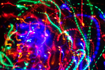 Chaotic lights in moriol blur out of focus - abstract photograph background.