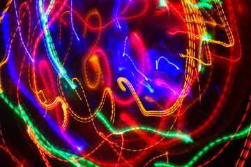 Chaotic lights in moriol blur out of focus - abstract photograph background.