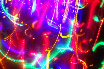 Chaotic lights in moriol blur out of focus - abstract photograph background.