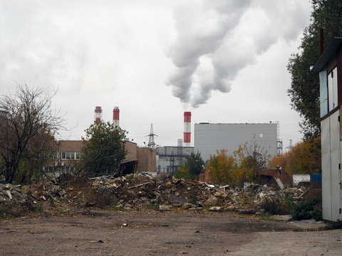 Most landfills. Pipes and smoke into the sky, Industrial Zone, autumn trees. The concept of ecology, environmental pollution