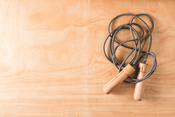 Top view of Skipping rope on wooden table background, Fitness li