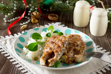 Fried fish in batter nut on a wooden Christmas table.