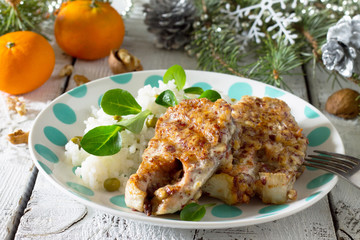 Baked fish in nut breading on the festive Christmas table.
