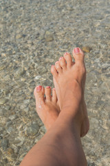 Female feet relaxing on the beach