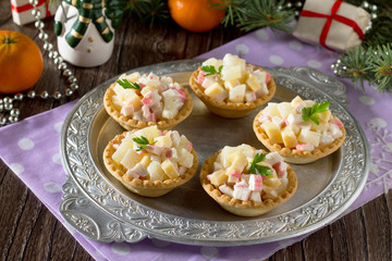 Holiday appetizer: tartlets with crab sticks, cheese and pineapp