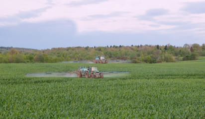 two tractors spraying