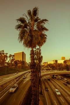 Vintage effected look of Freeway traffic speeding through downtown Los Angeles at dusk