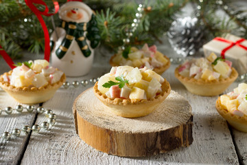 Holiday hors d'oeuvre: tartlets with crab sticks, cheese and pin