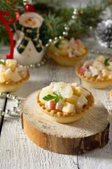 Holiday hors d'oeuvre: tartlets with crab sticks, cheese and pin
