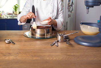 chocolate cake preparing on kitchen table with kitchenware