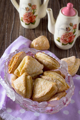 Cookies from puff pastry (shortcrust pastry with cheese) on a wo