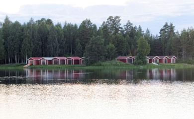 Group of red boathouse reflecting in the water