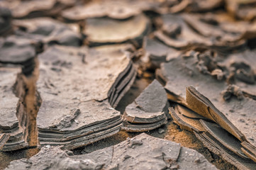 Layers of dried mud, earth texture, cracks in the soil