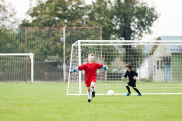 Little football player celebrates goal