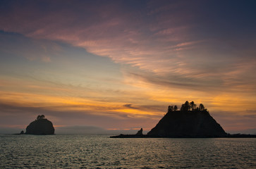 Naklejka na ściany i meble sunset over small islands in silhouette off the Washington coast on the La Push, Native American Reservation, USA