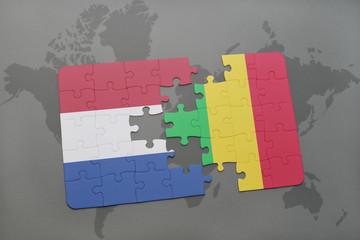 puzzle with the national flag of netherlands and mali on a world map background.