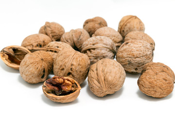 Walnuts in the shell and peeled kernels isolated on white background