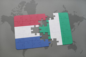 puzzle with the national flag of netherlands and nigeria on a world map background.