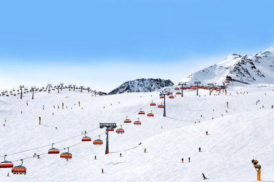 Skiers and chairlifts in Alpine ski resort in Solden in Otztal Alps, Tirol, Austria
