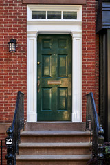 the front door of a brownstone building