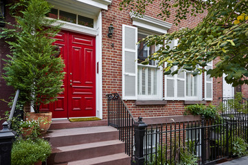 a colorful door on a brownstone building