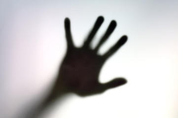 Silhouette of hand on a white surface