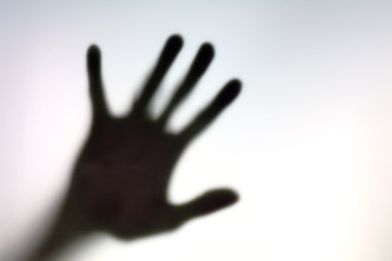 Silhouette of hand on a white surface