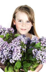 little girl with branches of lilac