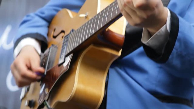 Musician playing vintage the guitar close-up.