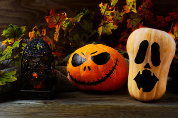Halloween decorated pumpkins on dark rustic background